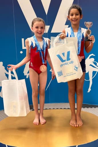 Two girls with medals and prizes