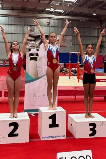 Girls in red on podium